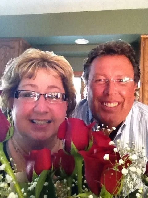 Dr. Cara Fawcett and Dr. Mark Kolosionek together, with a bunch of red roses.
